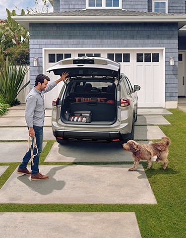 2024 Nissan Rogue rear view with liftgate open, showing a versatile cargo area with a Divide-N-Hide cargo system