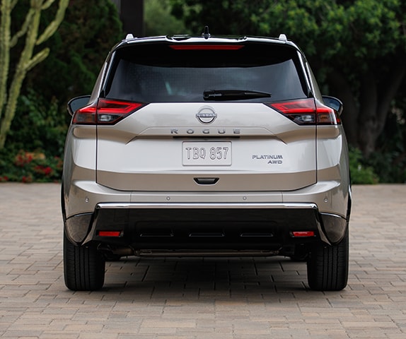 2024 Nissan Rogue parked in driveway, rear view