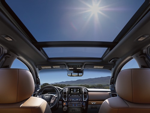 2024 Nissan TITAN view from backseat in day time with dual panoramic moonroof and sun shining in