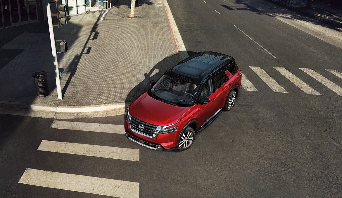 2024 Nissan Pathfinder view from above, turning through a city intersection.