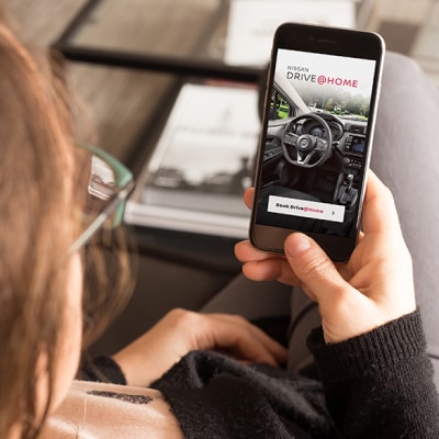 Individual booking a Nissan test drive online on a smartphone