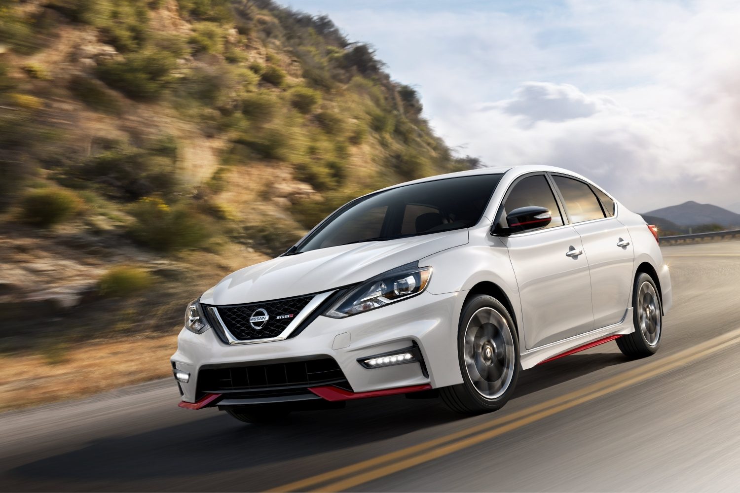 Nissan Sentra NISMO Exterior 3/4 front turning on mountain road