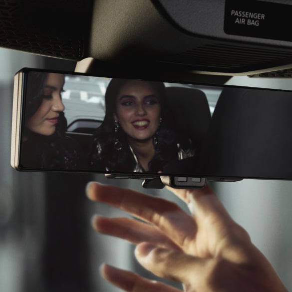 Hand adjusting Nissan's intelligent rear view mirror display.