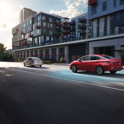 Nissan on road with Rear Cross-Traffic Alert safety technology.