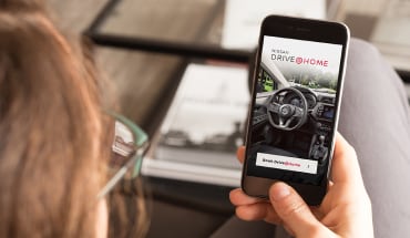 Person booking a Nissan test drive on a smartphone