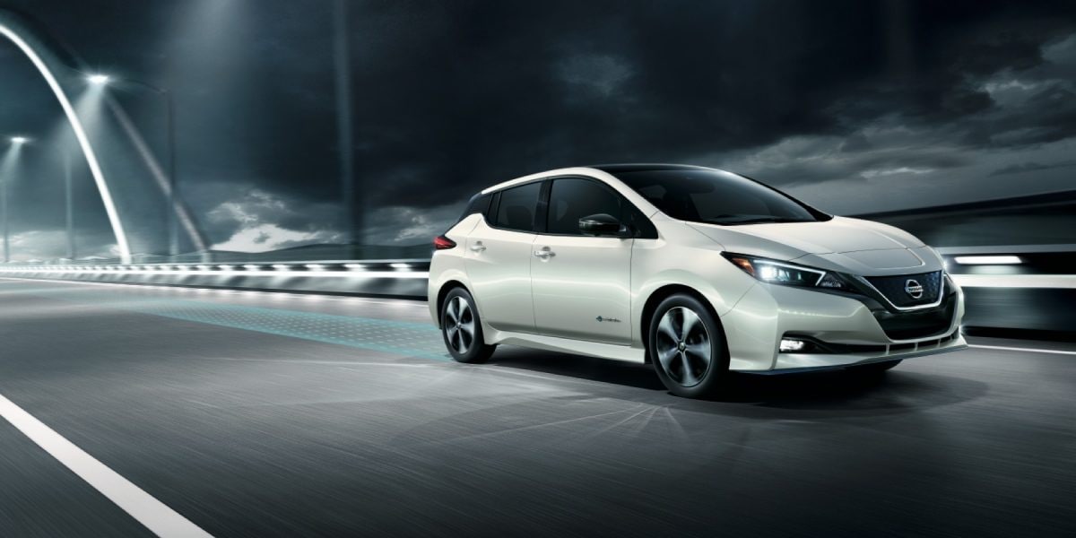 White Nissan LEAF SV Plus Driving on the Road