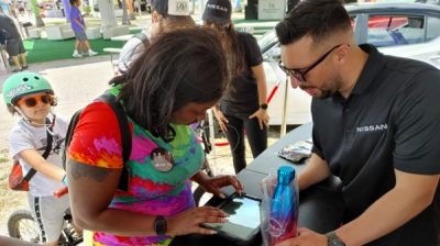 woman-entering-information-on-tablet-at-nissan-pride-event-in-miami