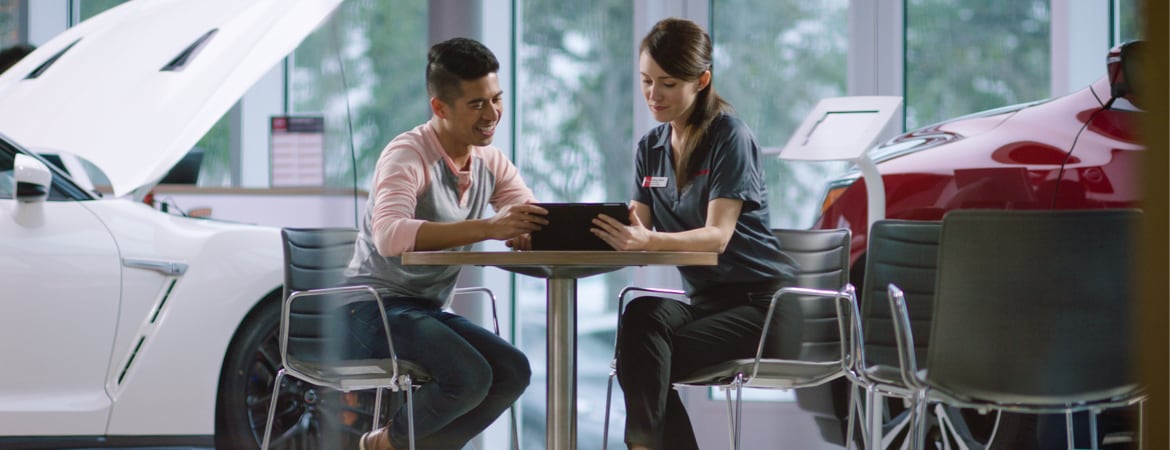 Nissan Employee Showing Man Gap Insurance On Tablet