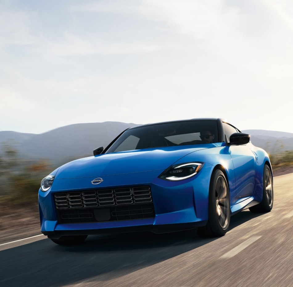 2024 Nissan Z in blue driving on a rural road at speed
