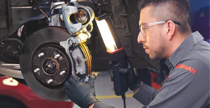 Nissan Technician Inspecting Brake Calipers