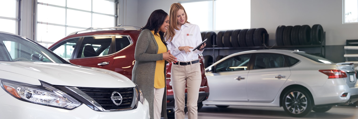 Two Women Exploring The Benefits Of Buying Nissan Certified Pre-Owned Vehicles