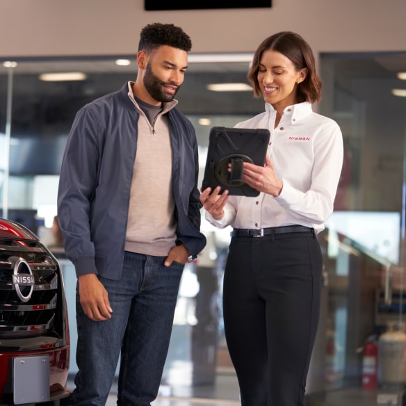 Nissan salesperson showing a client notes