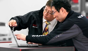 2021 Nissan GT-R engineers reviewing data on a laptop