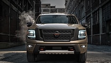 2021 Nissan TITAN in Baja Storm front view in an alley