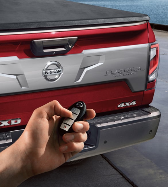 2021 Nissan TITAN showing a hand holding a fob and activating remote engine start system