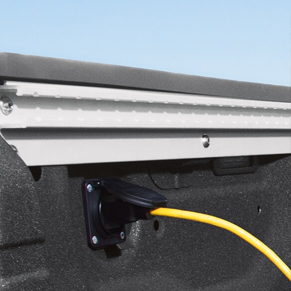 2021 Nissan TITAN bed showing yellow cord plugged in to 120-v outlet in