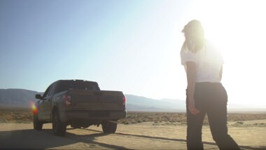Nissan TITAN person walking behind PRO-4X in the desert