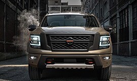 2022 Nissan TITAN in Baja Storm front view in an alley