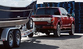 2022 Nissan Titan Crew Cab backing towing a boat.