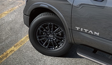 2023 Nissan TITAN 20-inch black aluminum-alloy wheel.