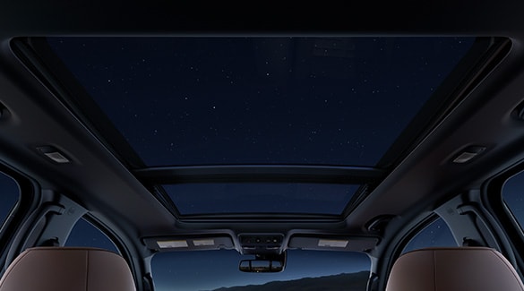 2023 Nissan TITAN view from backseat at night with dual panoramic moonroof and stars shining in.