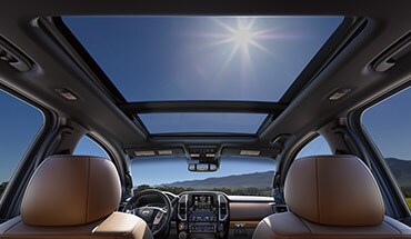 2023 Nissan TITAN view from backseat in day time with dual panoramic moonroof and sun shining in.
