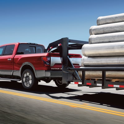  2024 Titan XD Truck towing 11,000 lbs of steel tubing on a commercial grade trailer