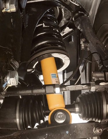 2024 Nissan TITAN PRO-4X closeup of yellow bilstein shock absorbers 