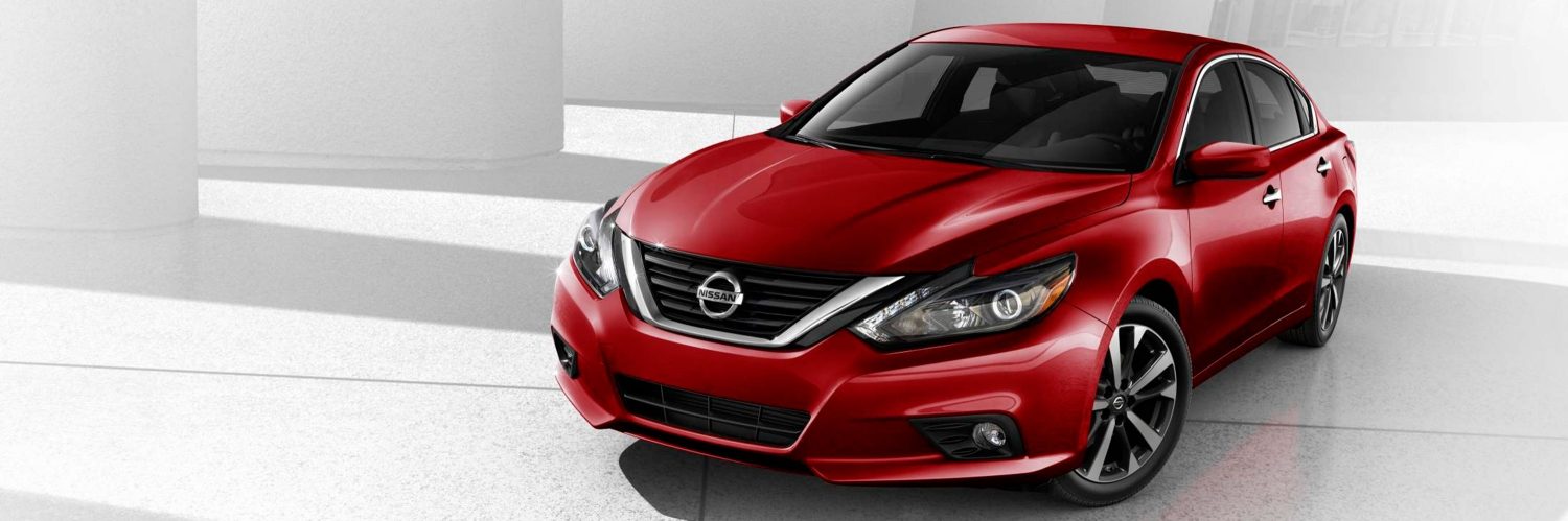 2016 Nissan Altima sedan, front side view, shown in Cayenne Red with V-Motion grille