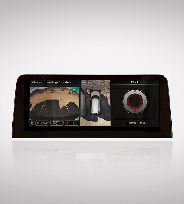 2022 Nissan Armada touch-screen on white background showing intelligent around view monitor camera views and clock.