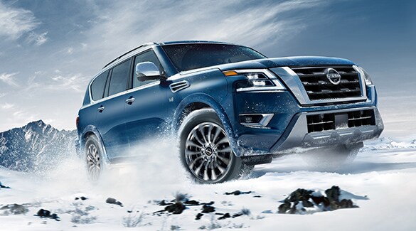 2023 Nissan Armada climbing a snowy hill to illustrate intelligent 4x4 capability.