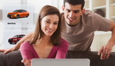 Two individuals shopping for Nissan products online from their home.