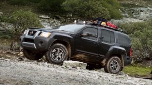 Profile View of Black Xterra with Roof Cargo