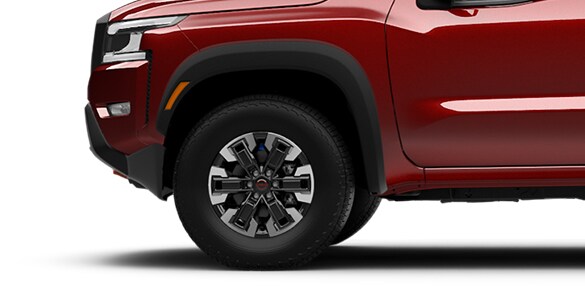 2022 Nissan Frontier 17-inch Dark-finished aluminum-alloy wheels with all-terrain tires.