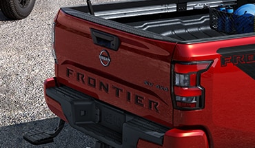 2023 Nissan Frontier black tailgate logo insert (3D lettering).