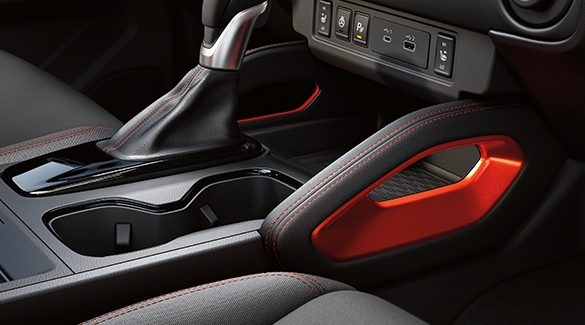 2023 Nissan Frontier center console showing lava red accents.