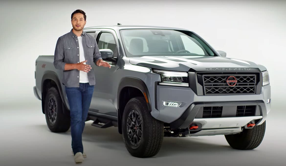 2024 Nissan Frontier in a white room with the walkaround video narrator beside it