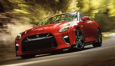 2021 Nissan GT-R in Solid Red taking a steering into a curve in the road