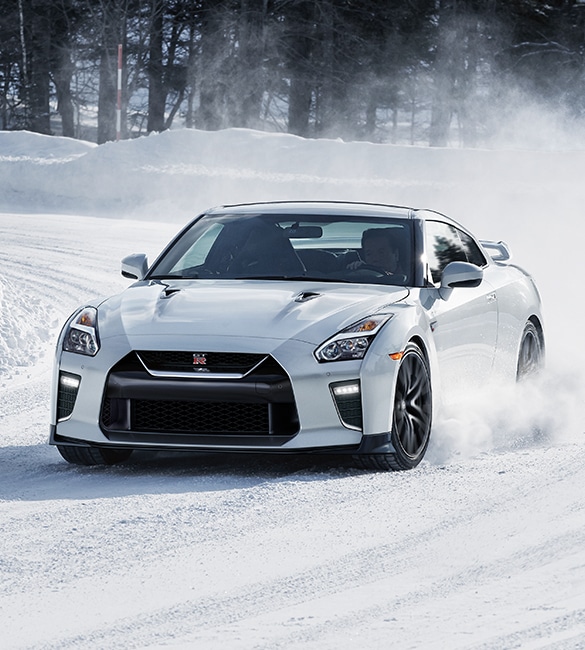 2021 Nissan GT-R in Pearl White taking a corner in the snow