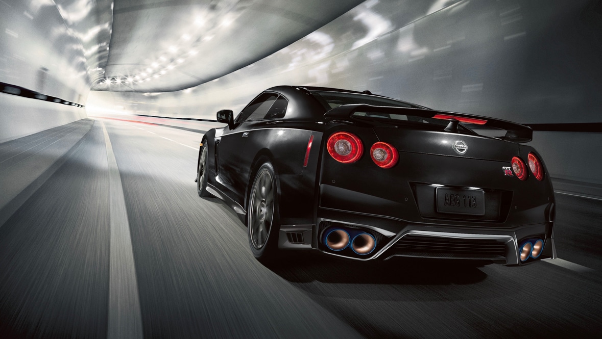 2021 Nissan GT-R in Jet Black Pearl seen from behind driving through a tunnel