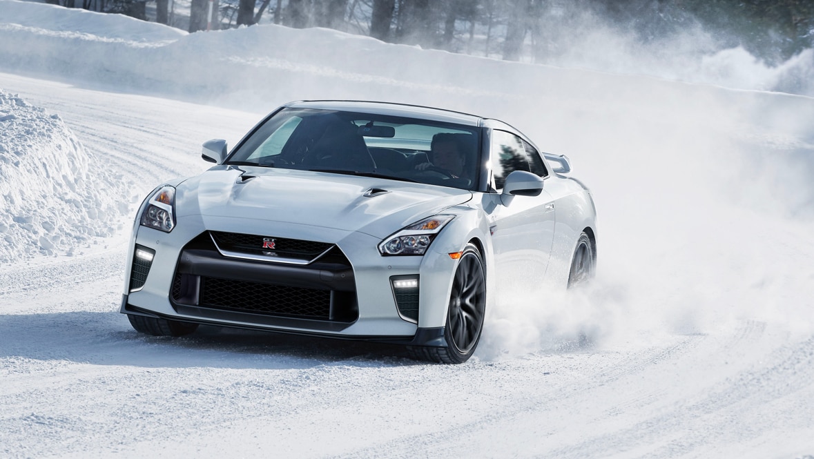 2021 Nissan GT-R in Pearl White taking a corner in the snow