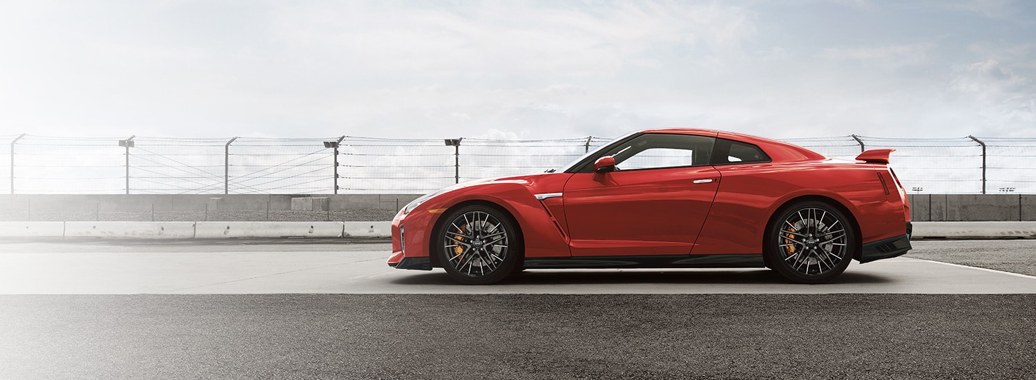 2023 Nissan GT-R in Solid Red drlving on a track.