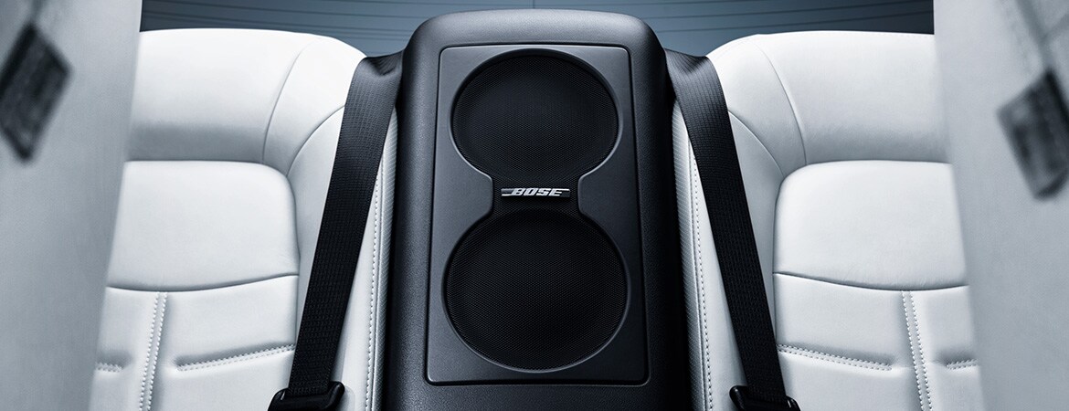 2024 Nissan GT-R interior view of rear seats showing subwoofer for Bose Premium Audio System.