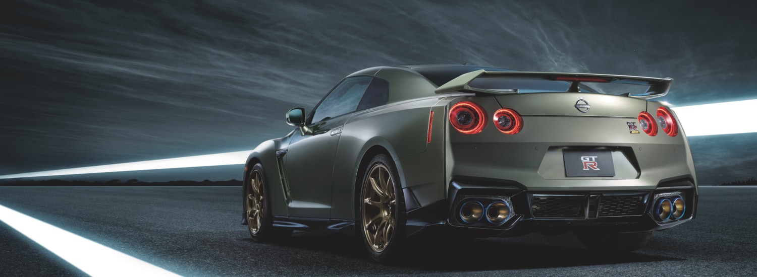 2024 Nissan GT-R in green, rear view, appearing to drive fast