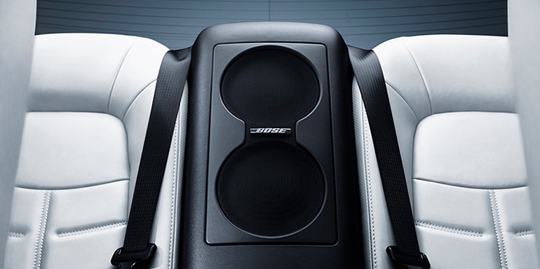 2024 Nissan GT-R interior view of rear seats showing subwoofer for Bose Premium Audio System.