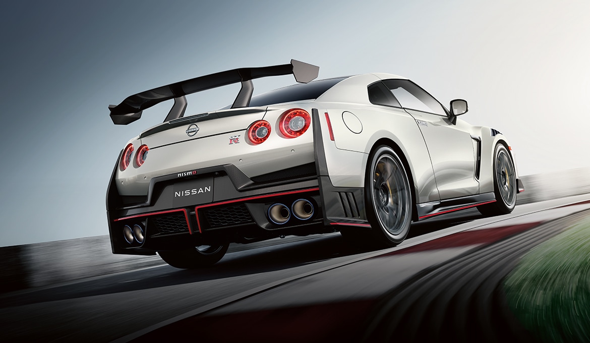 2024 Nissan GT-R driving on a racetrack, rear view.