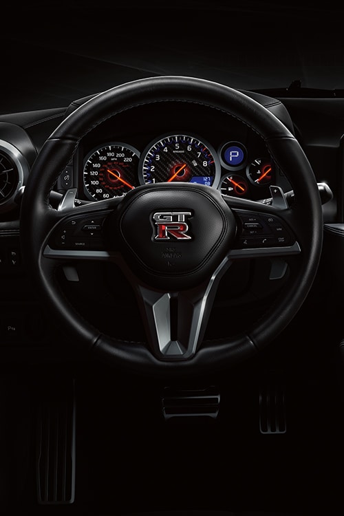 2024 Nissan GT-R detail of leather-wrapped steering wheel.