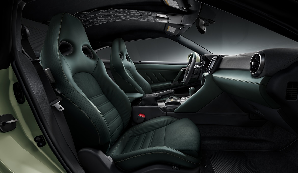 2024 Nissan GT-R T-spec interior view showing Mori Green aniline leather appointments and synthetic suede inserts.