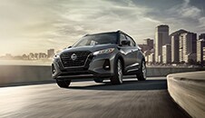 2022 Nissan Kicks in on a highway with city in background illustrating safety features