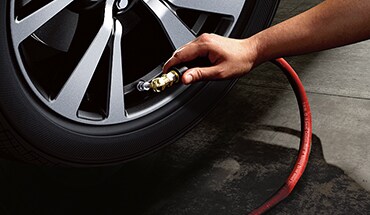 2022 Nissan Kicks person airing tire illustrating tire pressure monitoring system